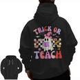 Trick Or Teach Halloween Teacher Floral Ghost Groovy Men Zip Up Hoodie Back Print, Groovy Teacher Gifts, trending gift