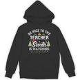 Christmas Be Nice To The Teacher Santa Is Watching Xmas Unisex Hoodie, trending gift Christmas Be Nice To The Teacher Santa Is Watching Xmas Unisex Hoodie, trending gift