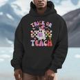 Trick Or Teach Halloween Teacher Floral Ghost Groovy Unisex Hoodie, novelty gifts, funny gifts
