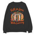 Fall In Love With Learning Book Lover Autumn Pumpkin Teacher Unisex Sweatshirt, trending gift