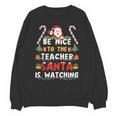 Be Nice To The Teacher Santa Is Watching Christmas Unisex Sweatshirt, trending gift Be Nice To The Teacher Santa Is Watching Christmas Unisex Sweatshirt, trending gift