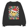 Santas Favorite Teacher Retro Groovy Smile Face Christmas Unisex Sweatshirt, Groovy Teacher Gifts, trending gift Santas Favorite Teacher Retro Groovy Smile Face Christmas Unisex Sweatshirt, Groovy Teacher Gifts, trending gift