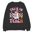 Trick Or Teach Halloween Teacher Floral Ghost Groovy Unisex Sweatshirt, Groovy Teacher Gifts, trending gift Trick Or Teach Halloween Teacher Floral Ghost Groovy Unisex Sweatshirt, Groovy Teacher Gifts, trending gift