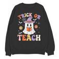 Trick Or Teach Teacher Groovy Ghost Halloween Teacher Unisex Sweatshirt, Groovy Teacher Gifts, trending gift Trick Or Teach Teacher Groovy Ghost Halloween Teacher Unisex Sweatshirt, Groovy Teacher Gifts, trending gift