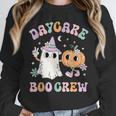 Daycare Boo Crew Groovy Halloween Floral Ghost Kid Teacher Unisex Sweatshirt, novelty gifts, funny gifts