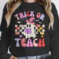 Trick Or Teach Halloween Teacher Floral Ghost Groovy Unisex Sweatshirt, novelty gifts, funny gifts Trick Or Teach Halloween Teacher Floral Ghost Groovy Unisex Sweatshirt, novelty gifts, funny gifts