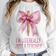 I'm Literally Just a Teacher Pencil Coquette Bow School Unisex Sweatshirt, novelty gifts, funny gifts I'm Literally Just a Teacher Pencil Coquette Bow School Unisex Sweatshirt, novelty gifts, funny gifts
