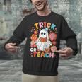 Groovy Halloween Trick Or Teach Retro Floral Ghost Teacher For Men Women Kids Unisex Sweatshirt, Groovy Teacher Sweatshirts, gift for family, gift for coworker Groovy Halloween Trick Or Teach Retro Floral Ghost Teacher For Men Women Kids Unisex Sweatshirt, Groovy Teacher Sweatshirts, gift for family, gift for coworker