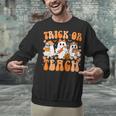 Groovy Teacher Halloween Trick Or Teach Ghost Men Women Kids Unisex Sweatshirt, Groovy Teacher Sweatshirts, gift for family, gift for coworker Groovy Teacher Halloween Trick Or Teach Ghost Men Women Kids Unisex Sweatshirt, Groovy Teacher Sweatshirts, gift for family, gift for coworker