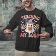Groovy Teaching My Boos Teacher Ghost Halloween Teacher Unisex Sweatshirt, Groovy Teacher Sweatshirts, gift for family, gift for coworker