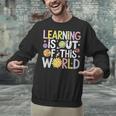 Learning Is Out Of This World Space Teacher Cute Groovy Unisex Sweatshirt, Groovy Teacher Sweatshirts, gift for family, gift for coworker