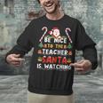Be Nice To The Teacher Santa Is Watching Christmas Unisex Sweatshirt, gift for family, gift for coworker Be Nice To The Teacher Santa Is Watching Christmas Unisex Sweatshirt, gift for family, gift for coworker