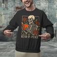 Read In Peace Skeleton Reading Book Halloween Teacher Unisex Sweatshirt, gift for family, gift for coworker Read In Peace Skeleton Reading Book Halloween Teacher Unisex Sweatshirt, gift for family, gift for coworker