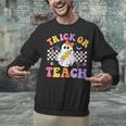 Trick Or Teach Groovy Halloween Teachers Unisex Sweatshirt, gift for family, gift for coworker Trick Or Teach Groovy Halloween Teachers Unisex Sweatshirt, gift for family, gift for coworker