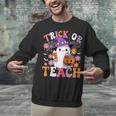 Trick Or Teach Groovy Teacher Ghost Halloween Teacher Unisex Sweatshirt, Groovy Teacher Sweatshirts, gift for family, gift for coworker