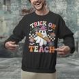 Trick Or Teach Groovy Teacher Halloween Retro Ghost Unisex Sweatshirt, Groovy Teacher Sweatshirts, gift for family, gift for coworker Trick Or Teach Groovy Teacher Halloween Retro Ghost Unisex Sweatshirt, Groovy Teacher Sweatshirts, gift for family, gift for coworker