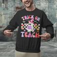 Trick Or Teach Halloween Teacher Floral Ghost Groovy Unisex Sweatshirt, Groovy Teacher Sweatshirts, gift for family, gift for coworker Trick Or Teach Halloween Teacher Floral Ghost Groovy Unisex Sweatshirt, Groovy Teacher Sweatshirts, gift for family, gift for coworker