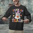 Trick Or Teach Teacher Groovy Ghost Halloween Teacher Unisex Sweatshirt, Groovy Teacher Sweatshirts, gift for family, gift for coworker Trick Or Teach Teacher Groovy Ghost Halloween Teacher Unisex Sweatshirt, Groovy Teacher Sweatshirts, gift for family, gift for coworker