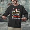 Be Nice To The Teacher Santa Is Watching Christmas Men Graphic Sweatshirt, gift for family, gift for coworker Be Nice To The Teacher Santa Is Watching Christmas Men Graphic Sweatshirt, gift for family, gift for coworker