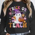 Trick Or Teach Groovy Teacher Ghost Halloween Teacher Women Crewneck Sweatshirt, Groovy Teacher Gifts, funny design Trick Or Teach Groovy Teacher Ghost Halloween Teacher Women Crewneck Sweatshirt, Groovy Teacher Gifts, funny design
