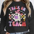 Trick Or Teach Halloween Teacher Floral Ghost Groovy Women Crewneck Sweatshirt, Groovy Teacher Gifts, funny design Trick Or Teach Halloween Teacher Floral Ghost Groovy Women Crewneck Sweatshirt, Groovy Teacher Gifts, funny design