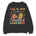 Groovy Fall In Love With Learning Autumn Pumpkin Teacher Women Crewneck Sweatshirt, novelty gifts, funny gifts