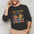 Groovy Fall In Love With Learning Autumn Pumpkin Teacher Unisex Long Sleeve T-Shirt, funny gift Groovy Fall In Love With Learning Autumn Pumpkin Teacher Unisex Long Sleeve T-Shirt, funny gift