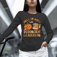 Fall In Love With Reading Book Autumn Pumpkins And Teachers Unisex Long Sleeve T-Shirt, novelty gifts, funny gifts