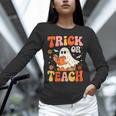 Trick Or Teach Halloween Shirt For Teacher Kids Floral Ghost Unisex Long Sleeve T-Shirt, novelty gifts, funny gifts