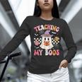 Groovy Teaching My Boos Teacher Ghost Halloween Teacher Women Long Sleeve T-Shirt, Groovy Teacher Shirts, gift for family, gift for coworker Groovy Teaching My Boos Teacher Ghost Halloween Teacher Women Long Sleeve T-Shirt, Groovy Teacher Shirts, gift for family, gift for coworker