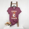 Halloween Teacher Shirts Women School Trick Or Teach Groovy Women's Heather T-Shirt Heather Maroon