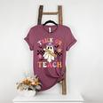 Trick Or Teach Groovy Teacher Halloween Retro Floral Ghost Women's Heather T-Shirt Heather Maroon Trick Or Teach Groovy Teacher Halloween Retro Floral Ghost Women's Heather T-Shirt Heather Maroon