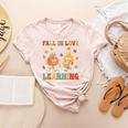 Groovy Fall In Love With Learning Autumn Pumpkin Teacher Women's Heather T-Shirt Heather Peach