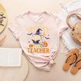 Spooky Teacher Halloween Cute Ghost Pumpkin Reading Women Women's Heather T-Shirt Heather Peach