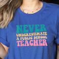 Never Underestimate A Public School Teacher Groovy Women Women's Heather T-Shirt Heather True Royal