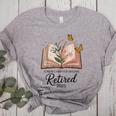 Retired 2025 A New Chapter Begins Retirement Teacher Book Women's Heather T-Shirt Athletic Heather Retired 2025 A New Chapter Begins Retirement Teacher Book Women's Heather T-Shirt Athletic Heather