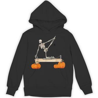 Skeleton Doing Reformer Pilates Machine Pumpkin Halloween Hoodie - Thegiftio UK