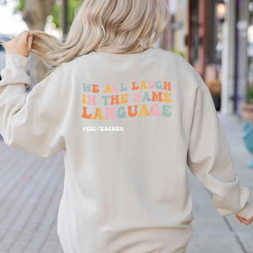 ESL Teacher We All Laugh In The Same Language Women's Sweatshirt Back Print - teacherstshirts.com