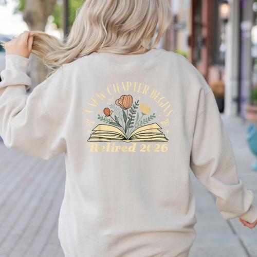 A New Chapter Begins Retired 2026 Teacher Retirement Women's Sweatshirt Back Print - teacherstshirts.com AU