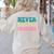 Never Underestimate A Public School Teacher Groovy Women Women's Sweatshirt Back Print Sand