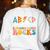 ABCD Kindergarten Rocks Back To School Teacher Kindergarten Women's Sweatshirt Back Print White