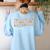 ESL Teacher We All Laugh In The Same Language Women's Sweatshirt Back Print Light Blue ESL Teacher We All Laugh In The Same Language Women's Sweatshirt Back Print Light Blue