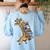 Teacher Shirt Giraffe Holding Books Bookworm Librarian Women's Sweatshirt Back Print Light Blue