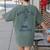 Fun 4th Of July Spilling The Tea Since 1773 History Teacher Women's Comfort Colors T-Shirt Back Print Moss