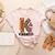K Is For Kindness Unity Day Teacher Kids Women's Heather T-Shirt Heather Peach K Is For Kindness Unity Day Teacher Kids Women's Heather T-Shirt Heather Peach