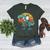 Boston Terrier Dog Riding Dinosaur T Rex Boys Women's Heather T-Shirt Heather Forest