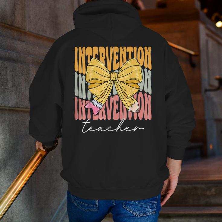 Interventionist Teacher Groovy Coquette Bow Back To School Men Zip Up Hoodie Back Print, Groovy Teacher Hoodies, funny gift