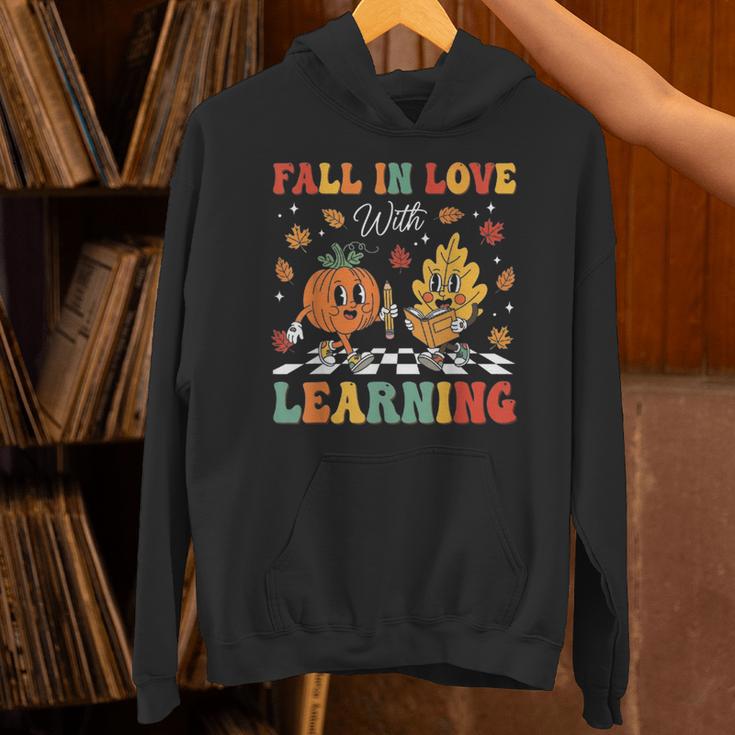 Groovy Fall In Love With Learning Autumn Pumpkin Teacher Unisex Hoodie, Groovy Teacher Hoodies, gift for family, gift for coworker