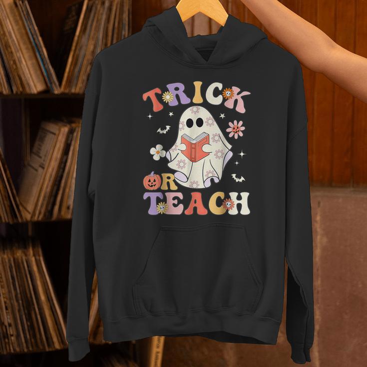 Groovy Halloween Trick Or Teach Retro Floral Ghost Teacher Unisex Hoodie, Groovy Teacher Hoodies, gift for family, gift for coworker