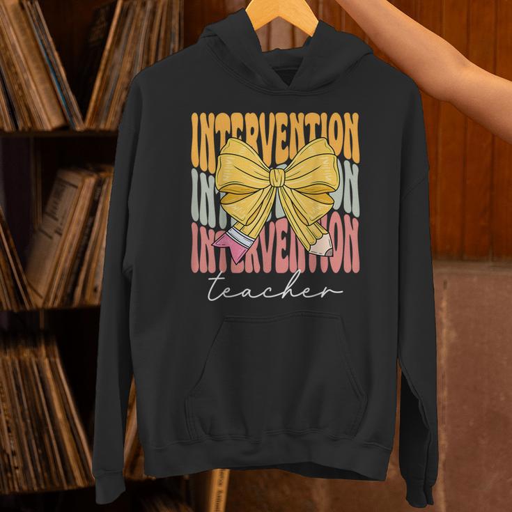 Interventionist Teacher Groovy Coquette Bow Back To School Unisex Hoodie, Groovy Teacher Hoodies, gift for family, gift for coworker Interventionist Teacher Groovy Coquette Bow Back To School Unisex Hoodie, Groovy Teacher Hoodies, gift for family, gift for coworker